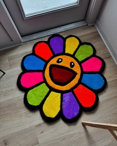 a colorful rug with a smiley face on the floor