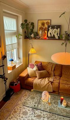 a living room filled with furniture and lots of plants on top of the windowsill