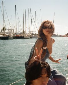 a woman sitting on the back of a boat