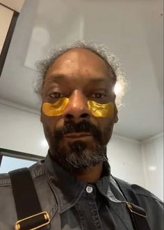 a man with yellow glasses on his face