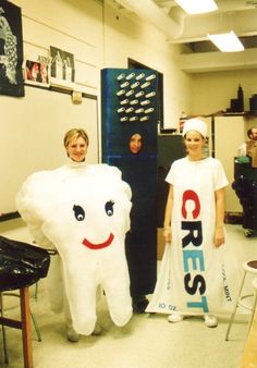 two women in costumes standing next to a tooth