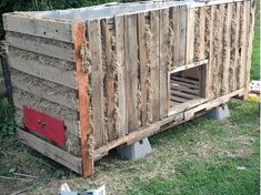 a dog house made out of pallet wood and some other items on the ground