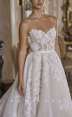 a woman in a white wedding dress with flowers on the skirt and headpieces