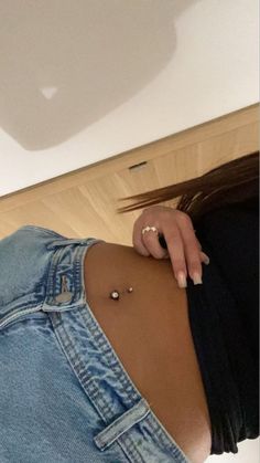 a woman with piercings on her stomach