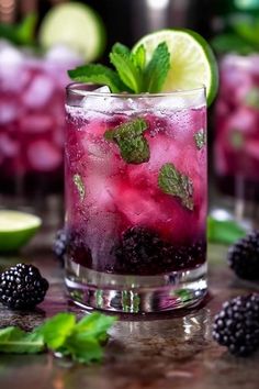 blackberry limeade cocktail with mint garnish on the rocks