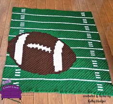 a crocheted rug with a football on it