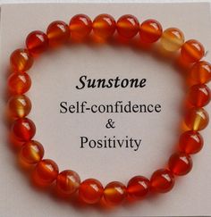 a bracelet with orange and yellow beads that says, sunstone self - confidence & positivity