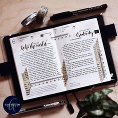 an open book sitting on top of a table next to a pen and some writing utensils