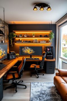 a home office with two computer screens on the wall and leather couches in front of it