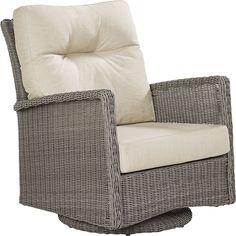 a wicker chair with a white cushion on top of it's back legs