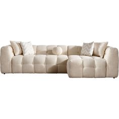 a white couch with pillows on it and a pillow in the middle of the couch