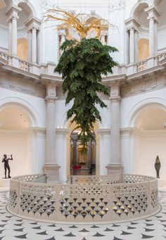 the interior of a large building with columns and arches