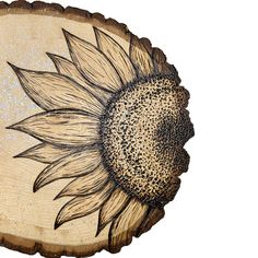 a sunflower painted on wood with glitters in the center and an oval shape