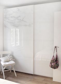 a white chair sitting in front of a sliding door