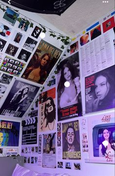 a bedroom with posters on the wall