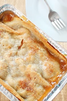 a casserole dish on a table with a fork