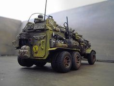 a toy army vehicle sitting on top of a table