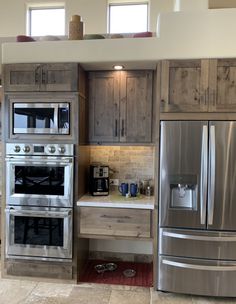 a kitchen with stainless steel appliances and wooden cabinets