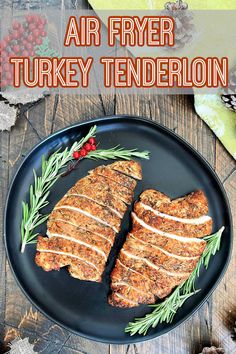 an air fryer turkey tenderie on a black plate with rosemary sprigs