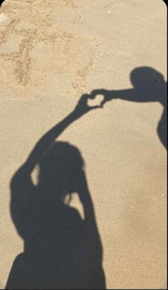 the shadow of a person holding a skateboard