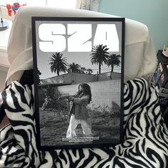 a black and white photo of a woman on a zebra print chair