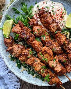 chicken skewers with rice and garnish on a plate