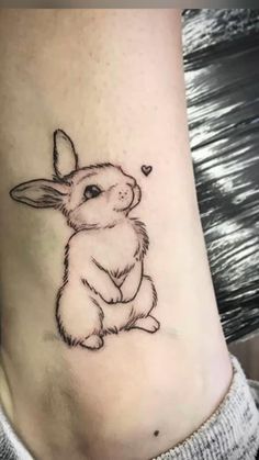 a small rabbit tattoo on the ankle