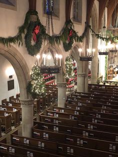 the interior of a church decorated for christmas