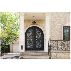 the front entrance to a home with wrought iron doors