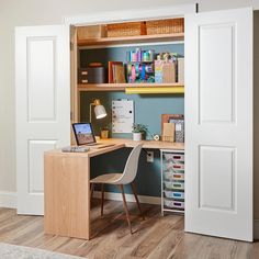 a desk with a laptop computer on top of it next to a book shelf filled with books