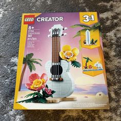 a lego guitar is sitting on the floor with flowers in it's case and instructions to make it look like an instrument