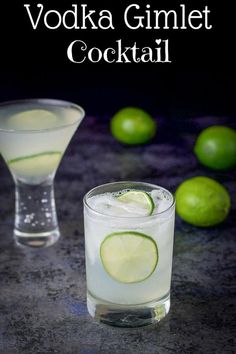 two glasses filled with vodka and limes next to each other