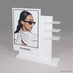 a chanel card with sunglasses on it is shown in front of a white background