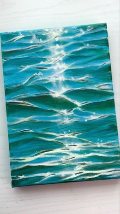 an acrylic painting of blue water with white waves on it's surface