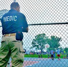 a man holding a tennis racquet on top of a tennis court next to a fence