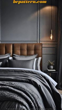 the bed is made up with black and white linens, along with a brown headboard