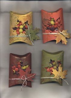 four decorative plates with autumn leaves and acorns on them