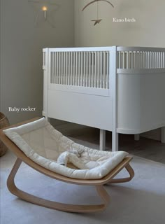 a baby crib with a rocking chair next to it