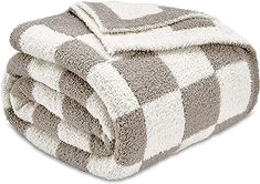 three towels stacked on top of each other in grey and white checkerboard pattern