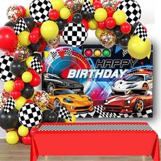 a birthday party with cars and balloons on the wall, including a red table cloth