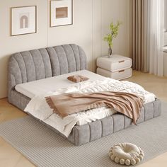 a bed sitting on top of a wooden floor next to a window