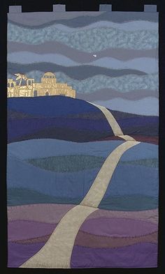 a quilted wall hanging with a road leading to a castle in the distance and clouds