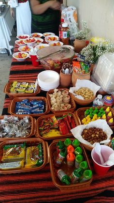 a long table with many trays of food on it