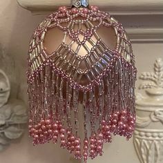 a pink beaded ornament hanging from the ceiling