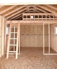 the inside of a house being built with wooden framing and ladders on the floor