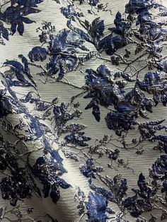 blue and silver fabric with flowers on it