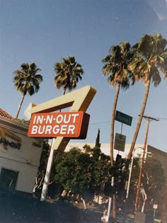 a sign that says in - n - out burger on the side of a building