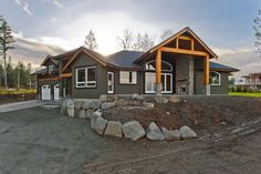 a large house with lots of rocks in front of it