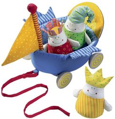 a toy wagon filled with toys on top of a white surface