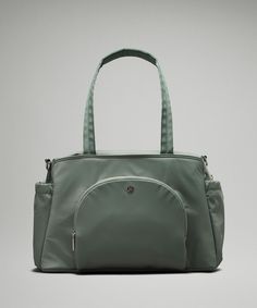 a green handbag on a gray background